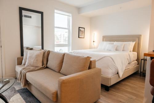 a bedroom with a bed and a couch at Elegant Apartment in the Heart of Hollywood in Los Angeles