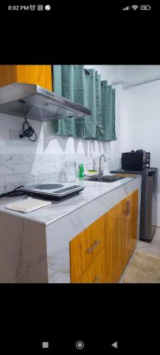 a kitchen with a sink and a counter top at Kylitas transient house studio apartment 1st floor in Tagbilaran City