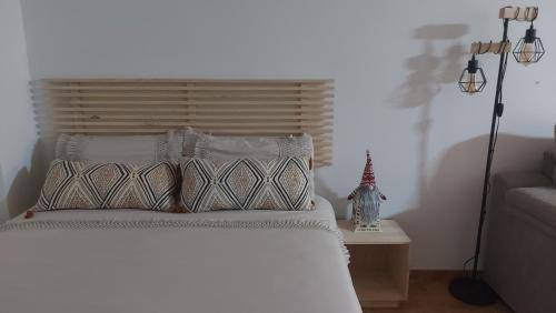 een slaapkamer met een wit bed met 2 kussens bij Loft Aguas de la Sierra in Benamahoma