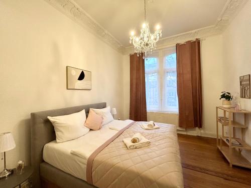 a bedroom with a bed with two towels on it at IDEE Living: Traumhaftes Altbau Apartment - Balkon in Wiesbaden