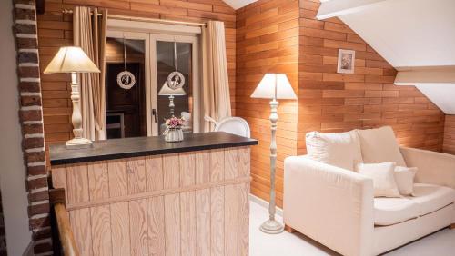 a home bar with a white chair and a mirror at Le Colibri spa jacuzzi in Durbuy