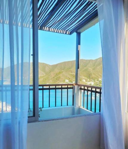 a balcony with a view of the ocean and mountains at Apartaestudio en la Montaña de Taganga in Santa Marta
