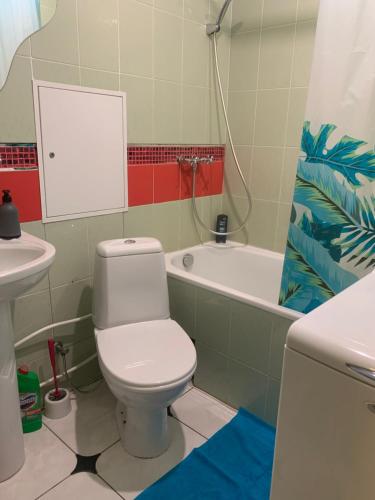 La salle de bains est pourvue de toilettes, d'un lavabo et d'une baignoire. dans l'établissement Podil Apart Сковороди Kontraktova Ploscha, à Kiev