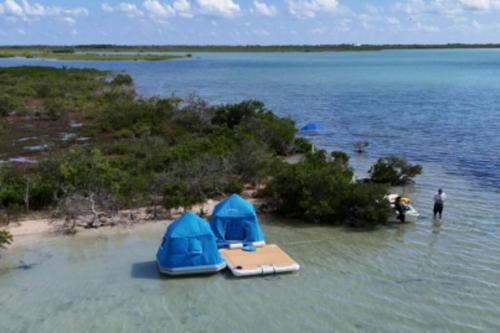 two tents on the shore of a body of water at Bonnethead Key Floating Campground and Private Island in Key West
