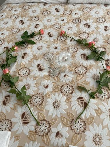 a bed with white and brown flowers on it at Mia Property - Two Mile Hill in Bristol