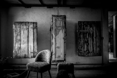 a room with two chairs and two open windows at Inter Artes Prestige House and Luxury Suite in Viterbo
