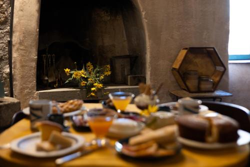 a table topped with plates of food and drinks at Inter Artes Prestige House and Luxury Suite in Viterbo