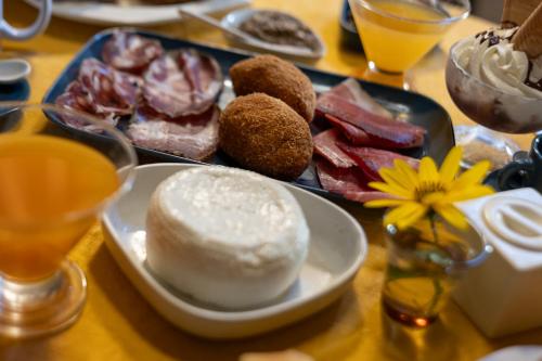 a table with a plate of food on a table at Inter Artes Prestige House and Luxury Suite in Viterbo