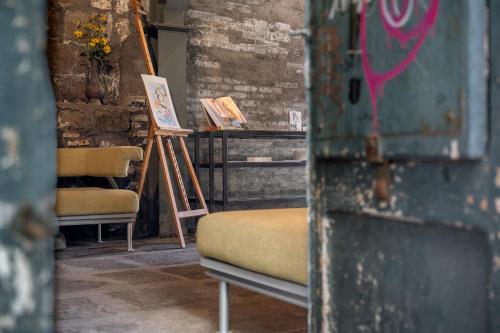 a room with two chairs and a couch and a painting at Inter Artes Prestige House and Luxury Suite in Viterbo