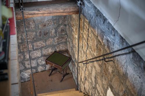 a stone wall with a bench sitting on top of it at Inter Artes Prestige House and Luxury Suite in Viterbo