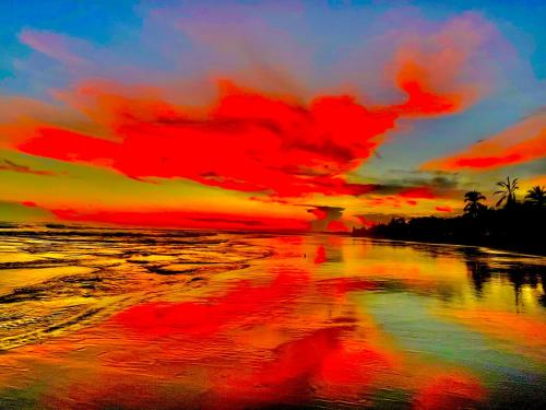 a painting of a sunset on the beach at Beachfront Paradise in Manuel Antonio