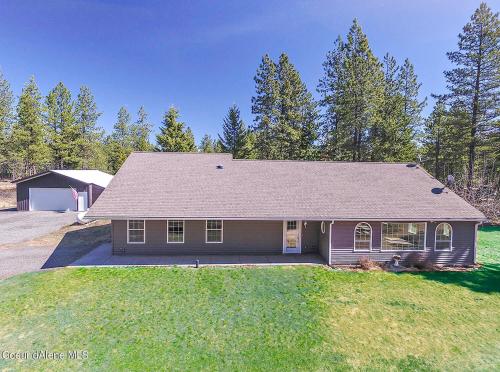 a house with a roof on a grass field at Riffle Road Ranch in Spirit Lake