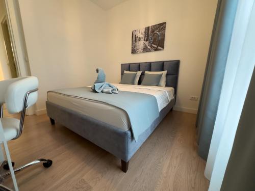 a bedroom with a bed with a stuffed animal on it at Exceptional Belgrade Waterfront Apartment - Beograd na Vodi in Belgrade