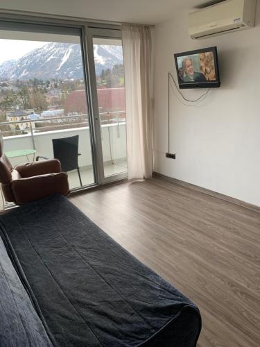 a bedroom with a bed and a window with a view at Reichenbach Apartment in Bad Reichenhall