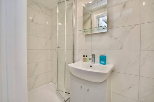 a white bathroom with a sink and a shower at Dane Duplex Studio 3 – Coventry in Coventry