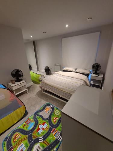 a bedroom with a bed and a rug on the floor at Rent Luxuri - Luxury 2 bed Apartment in Leicester