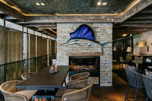 a fireplace in a restaurant with a table and chairs at Element Amsterdam in Amsterdam