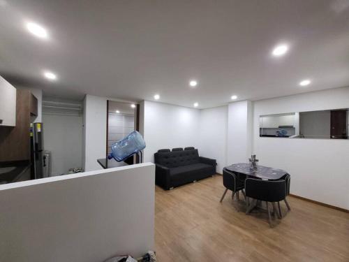 a living room with a couch and a table at Aparment comfort deluxe cajica in Cajicá