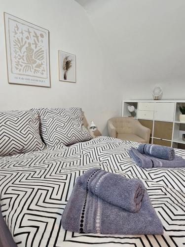 a bedroom with a bed with two towels on it at Modern Studio near Düsseldorf Airport & Messe/Fair in Meerbusch