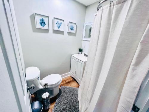 a bathroom with a toilet and a shower curtain at Entire Lovely 3 Bedroom, 2 Bathroom Apartment! 1 Block to the Beach and Boardwalk! in Wildwood