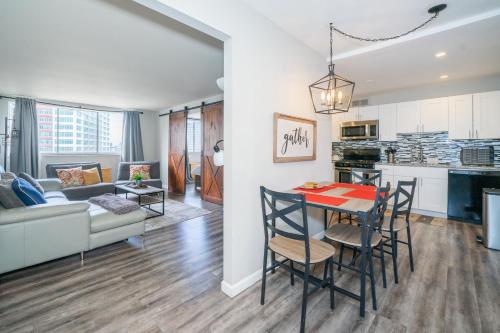 a kitchen and living room with a table and chairs at Welcoming Barn, 2 BEDROOM & 1 Bath & Parking in Atlanta