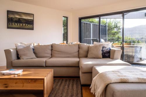 a living room with a couch and a table at The Bolthole in Coles Bay