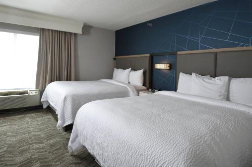 a hotel room with two beds and a window at SpringHill Suites Des Moines West in West Des Moines