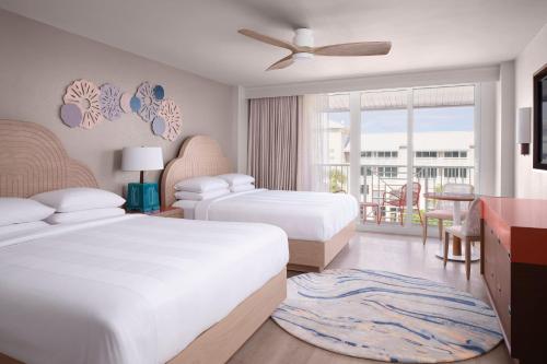 a hotel room with two beds and a balcony at Marriott Hutchinson Island Beach Resort, Golf & Marina in Stuart