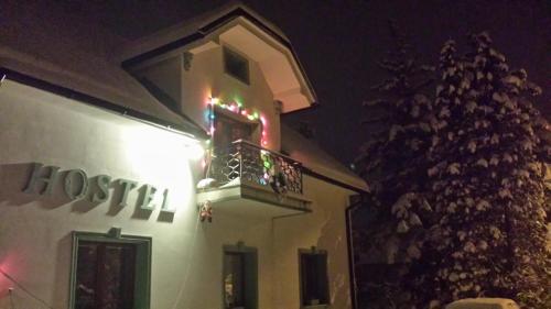 a building with a balcony with christmas lights on it at Mama's House in Cerklje na Gorenjskem