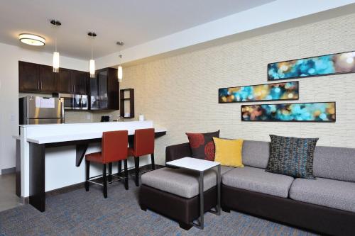 a living room with a couch and a kitchen at Residence Inn by Marriott Houston Tomball in Tomball
