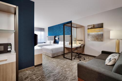 a hotel room with a bed and a desk at SpringHill Suites by Marriott Phoenix Scottsdale in Scottsdale