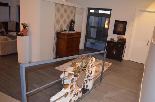 a living room with a table and a glass case at Casa de Campo de SOUTELO in Soutelo