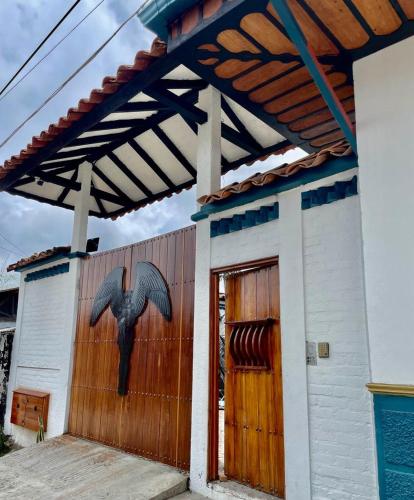 a building with a bird painted on the side of it at Hotel San Miguel de Salento in Salento