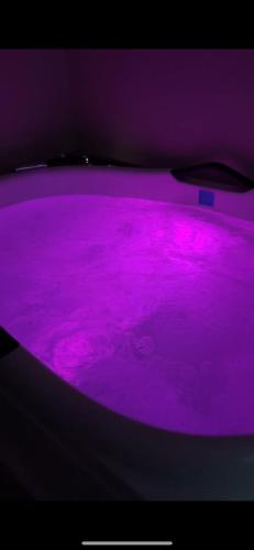 a purple bath tub filled with purple liquid at Playa Del Sol Surf House in Tamraght Ouzdar