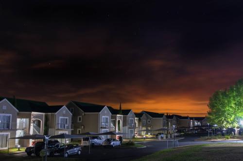 a row of houses in a parking lot at night at Protea Hotel by Marriott Stellenbosch & Conference Centre in Stellenbosch