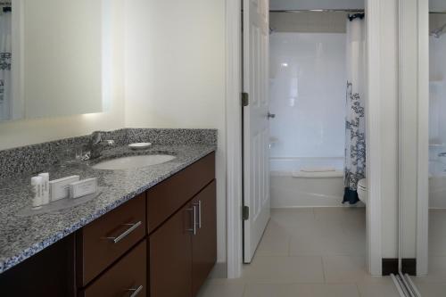 a bathroom with a sink and a shower at Residence Inn Mystic Groton in Mystic