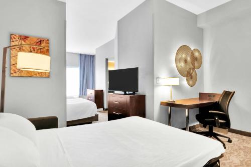 a hotel room with a bed and a desk at SpringHill Suites by Marriott Tarrytown Westchester County in Tarrytown