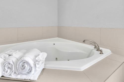 a white bath tub with towels in a bathroom at SpringHill Suites by Marriott Tarrytown Westchester County in Tarrytown