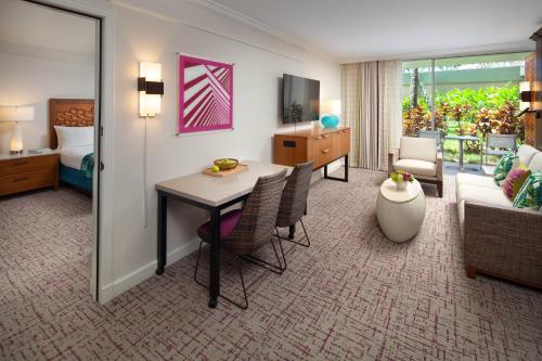 a hotel room with a table and a living room at Marriott's Kaua'i Beach Club in Lihue