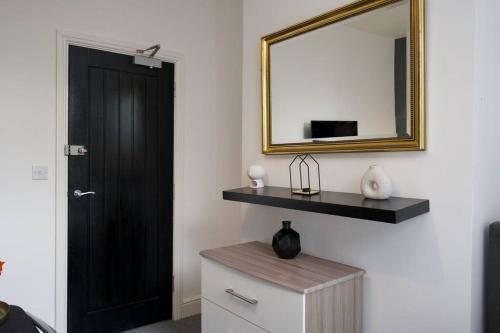 a room with a black door and a mirror at Gordon House - 4Bed Coventry City Centre Oasis with Free Parking in Coventry