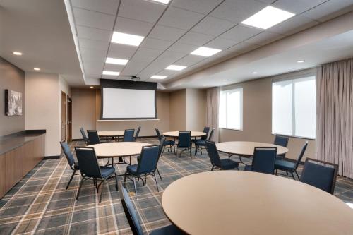 a conference room with tables and chairs and a projection screen at Residence Inn by Marriott Vail in Vail