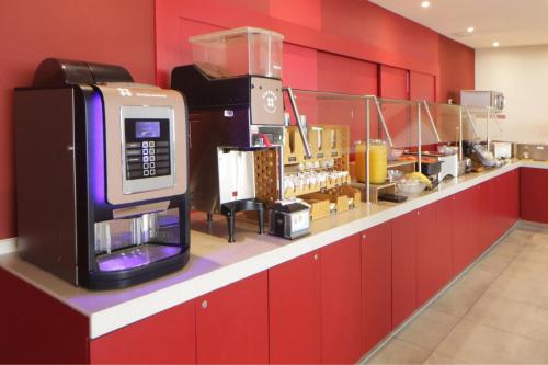 a kitchen with a counter with a microwave at City Express Junior by Marriott Tijuana Otay in Tijuana