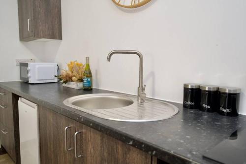 a kitchen counter with a sink in the middle of it at Matlock Studio 1 - Coventry in Coventry