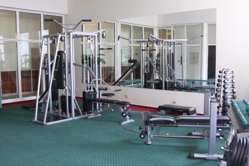 a gym with several treadmills and machines at Hotel Bristol in Karlovy Vary