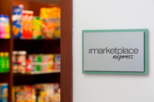 a sign on the door of a store with a market diligenceagent sign at Marriott's Kauai Lagoons - Kalanipu'u in Lihue