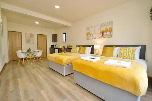 a large bedroom with two beds and a table at Matlock Studio 2 – Coventry in Coventry