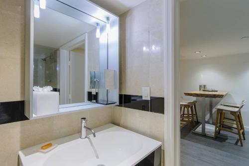 a bathroom with a sink and a mirror at Marriott Vacation Club®, South Beach    in Miami Beach