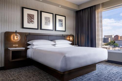 a bedroom with a large bed and a large window at Delta Hotels by Marriott Wichita Falls Convention Center in Wichita Falls
