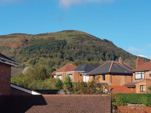 a hill in the distance with houses and a mountain at Cavehill View. An elegant 4 bedroom detached house. Your perfect Belfast retreat! in Belfast