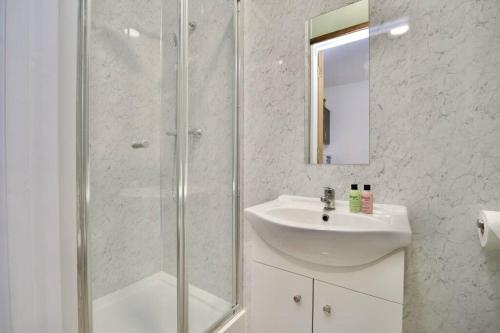 a white bathroom with a sink and a shower at Matlock Studio 5 - Coventry in Coventry